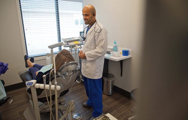 Dr. Seyar Baqi, a dentist at his practice Blue Hen Dental, in Smyrna, talks with a patient during her visit in this file photo.