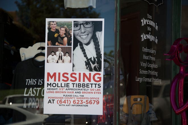 A poster with information about Mollie Tibbetts, a missing 20-year-old University of Iowa student, hangs in the window on a business in downtown Brooklyn on Tuesday, July 24, 2018, in eastern Iowa.