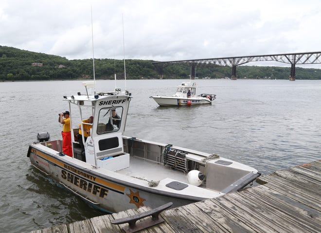 Boats from Dutchess and Ulster County sheriffs departments search the waters between the Mid-Hudson bridge and the Walkway Over the Hudson on July 25, 2018. A swimmer went missing in the Hudson River Tuesday and multiple departments continue the search. 