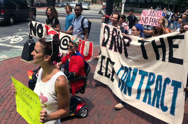 In this July 11, 2018 file photo, students and community activists march at Northeastern University in Boston demanding the school cancel a multimillion-dollar research contract with U.S. Immigration and Customs Enforcement. Northeastern was hired by ICE to research U.S. technology exports.