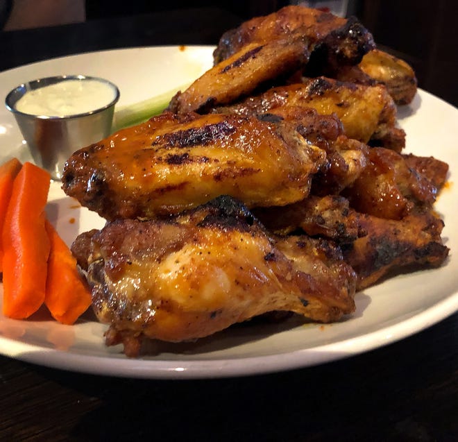Bo's Signature Wings. The menu says, "bo's killer b wings are tossed in a combination of medium, bbq & garlic sauce & then grilled to perfection." Large, $26, Small $14. National Chicken Wing Day is July 29, so where can you find great wings in Collier and south Lee counties?The photo was taken in Naples, FL. Tuesday  July 14, 2018.