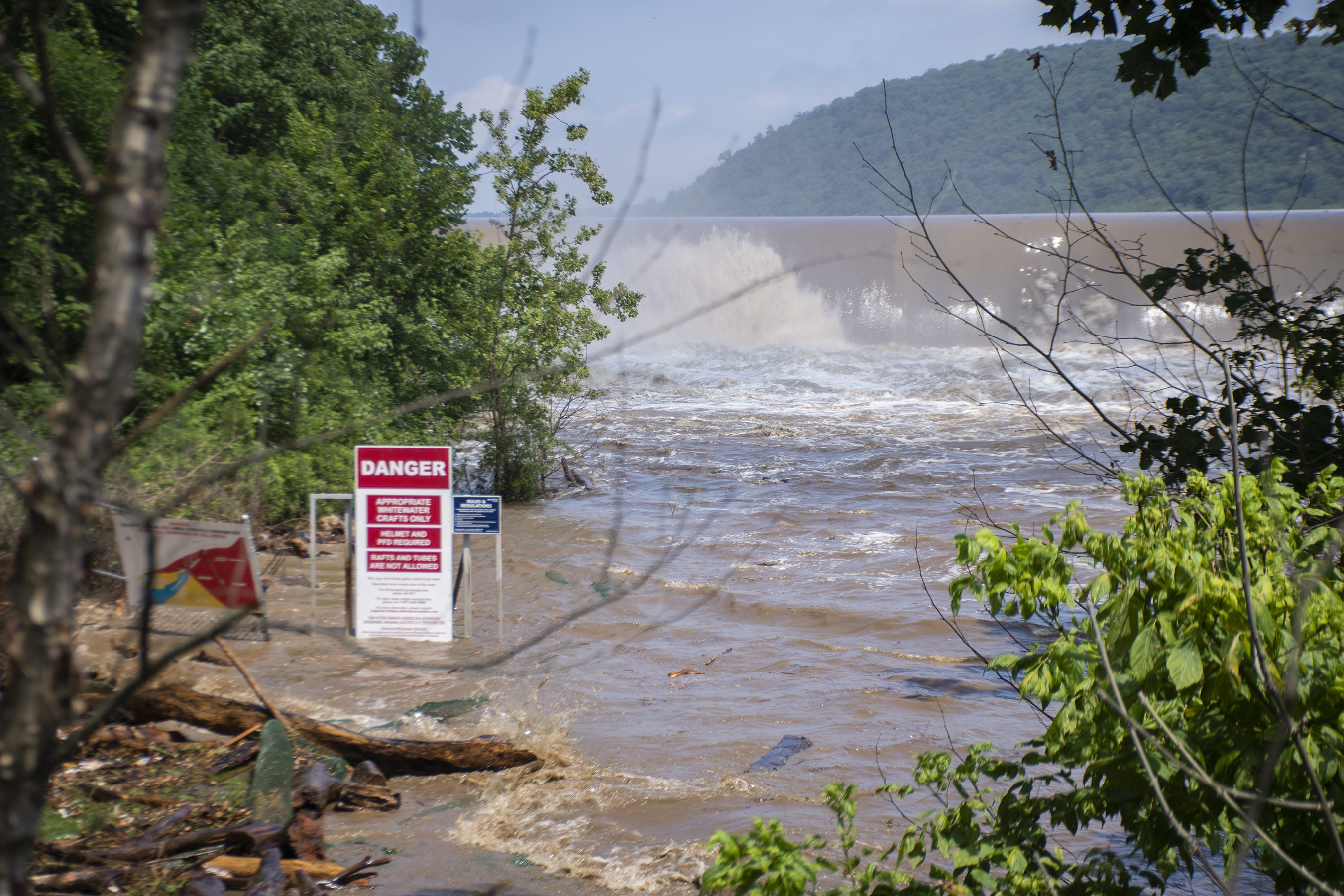 A sign warns of the dangerous high and fast water at the Conowingo Dam in Darlington, Maryland on Thursday, July 26, 2018.