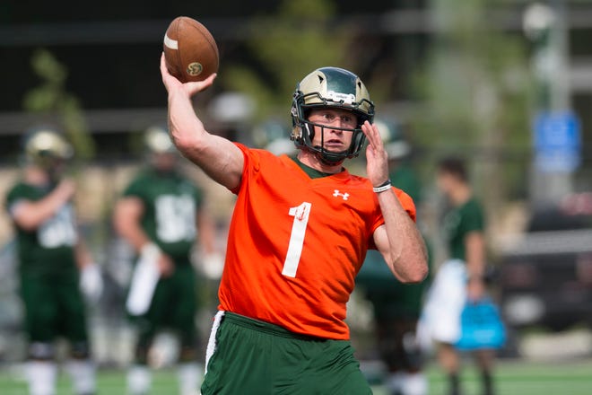 CSU quarterback K.J. Carta-Samuels throws the ball during the Rams' first practice of the season outside of Canvas Stadium on Friday, July 27, 2018. 