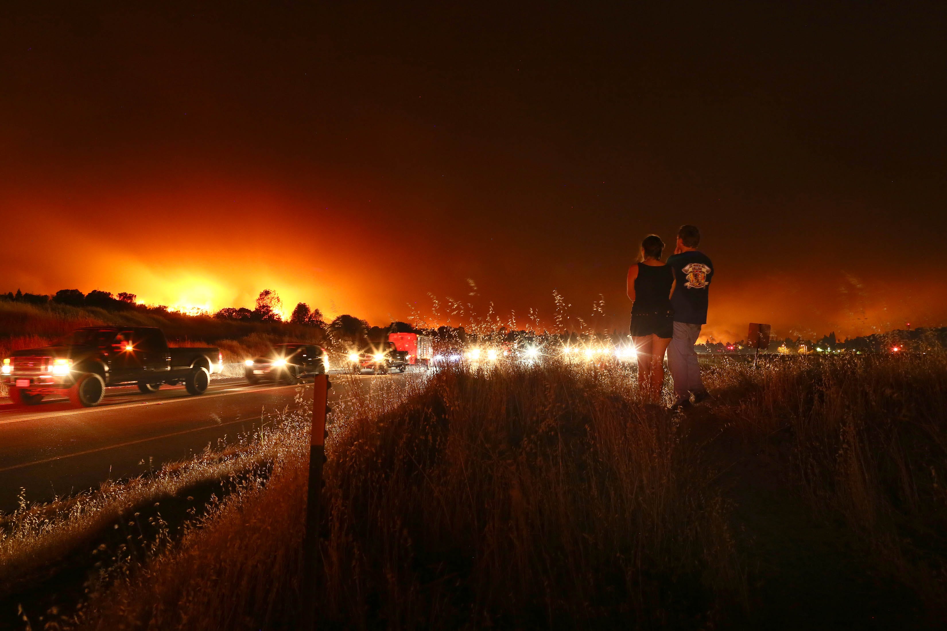 Carr Fire - Redding is under evacuation on Thursday night as the Carr fire make it way into the city. A long line of traffic on Buenaventura Blvd along Benton Air Park. Power outage in many subdivision, Streets closure into areas of burning. (photo by Hung T. Vu)