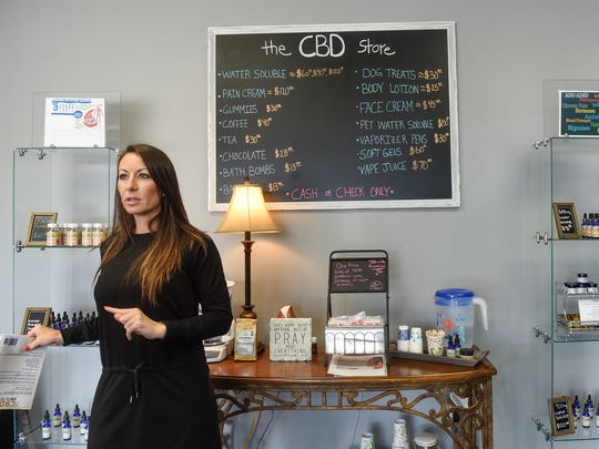 Marie Schneider outlines products available during an interview Thursday, July 26, at CBD Hemp Dropz of St. Cloud.