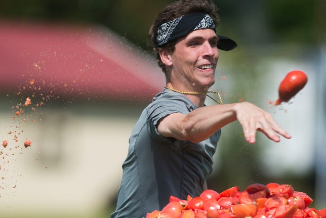 Harrison Heins of Knoxville chucks a tomato at the Grainger County Tomato Festival Saturday, July 28, 2018.