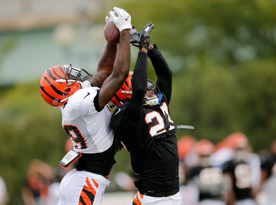 Cincinnati Bengals wide receiver Auden Tate (19) catches a pass over defensive back Dre Kirkpatrick (27) during a camp practice session at the Paul Brown Stadium practice facility in downtown Cincinnati on Monday, July 30, 2018.