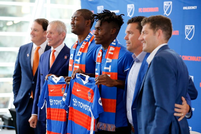 New team signees Fenando Adi and Fatai Alashe pose with (left to right) general manage Jeff Berding, owner Carl Lindner III, team manager Alan Koch and technical director Luke Sassano.
