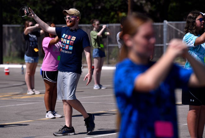 Abilene High School assistant band director Tyler Jacks holds a device for marking time as he instructs the Eagle Band freshmen in marching July 31. Jacks is assistant to Director Jonathan Kraemer, who took over for the retired Paul Walker this summer.