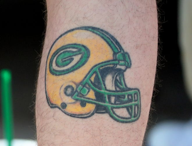 A fan with a Green Bay Packers calf tattoo at Packers training camp in 2018.