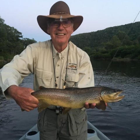 Bob Meyan holds a 23-inch brown trout he caught in