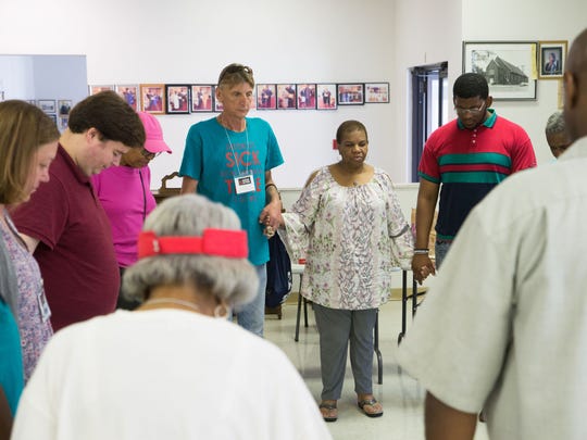 MOSES Action volunteer canvassers participate in a prayer circle before canvassing in Detroit on Aug. 2, 2018.