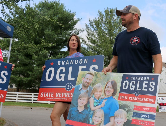 House District 61 candidate Brandon Ogles stands with his wife, Grace, at the Hunters Bend Elementary School polling location Aug. 2, 2018.