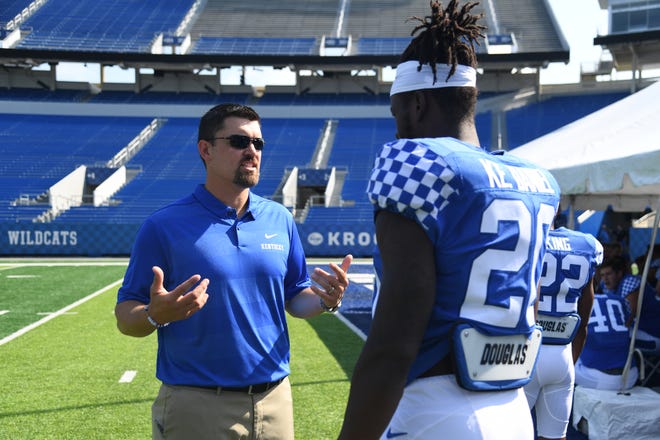 Inside linebackers coach Brad White instructs DE Kengera Daniel during the UK football media day at Kroger Filed in Lexington, Kentucky on Friday, August 3, 2018. 