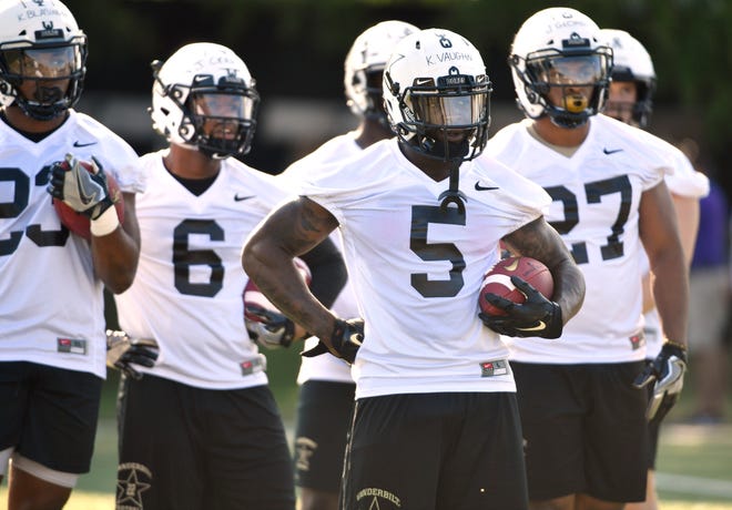 Vanderbilt's Ke'Shawn Vaughn (5) and his fellow running backs wait for a drill to start during practice Aug. 3.