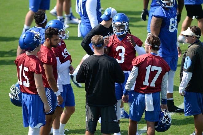 Assistant coach Darin Hinshaw talks with quarterbacks during the UK football Fan Day at Nutter practice field in Lexington, Kentucky on Saturday, August 4, 2018. 