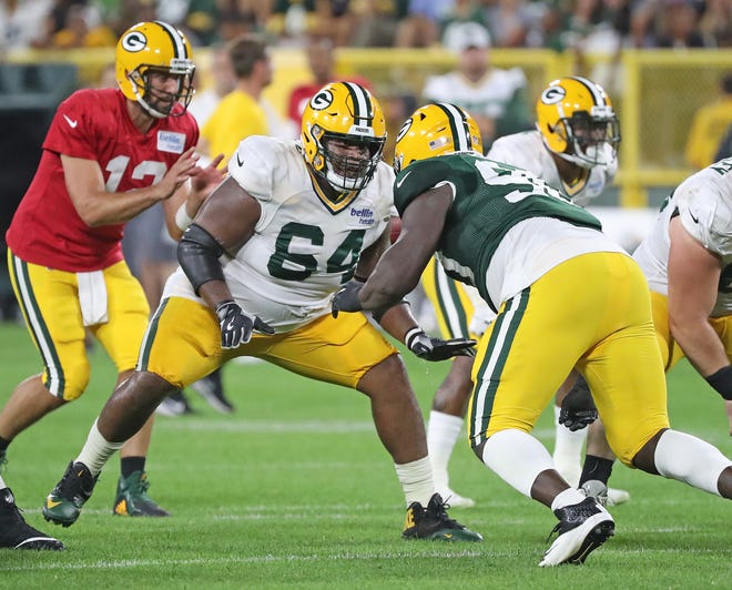 Green Bay Packers offensive guard Justin McCray (64) blocks defensive tackle Montravius Adams (90) during Green Bay Packers Family Night  Saturday, August 4, 2018 at Lambeau Field in Green Bay, Wis.,