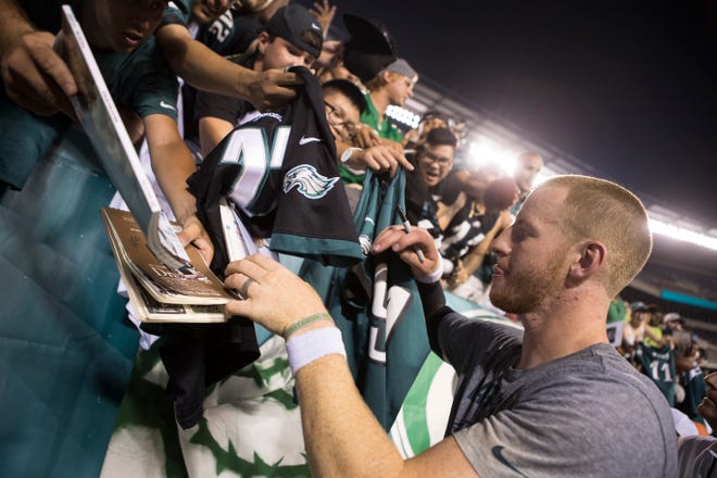 Eagles' Carson Wentz (11) signs autographs for fans after practice Sunday at Lincoln Financial Field. 