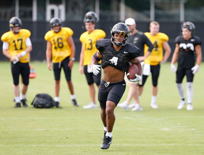 Wide receiver Rondale Moore runs after a pass reception during football practice Tuesday, August 7, 2018, at Purdue.