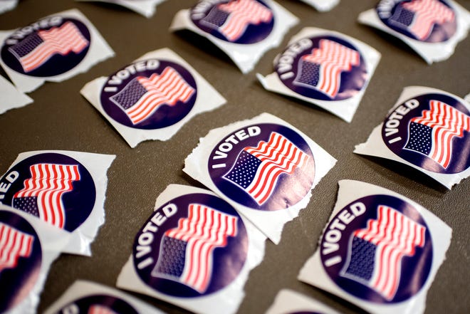 Stickers for voters are displayed on a table at the polling place at Pattengill School on Tuesday, Aug. 7, 2018, in Lansing.
