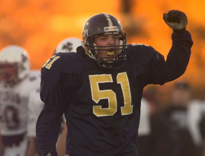 Victor's Jeremie Brass celebrates a fumble recovery against Aquinas in a  1998 game.