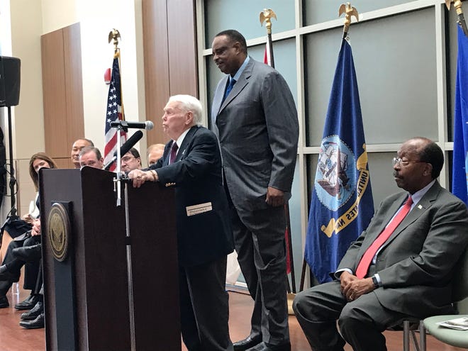 Monticello Dr. Jim Sledge, l, at the request of Rep. Al Lawson, r, tells a story about his childhood friend Boots Thomas at the rededication ceremony to name Tallahassee's VA Clinic after Boots, a hero of the Battle for Iwo Jima.