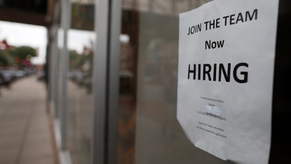 A "now hiring" sign hangs in the window of a Chinese restaurant in downtown Fargo, N.D. Data shows that small businesses are hiring less, despite the strong economy, partly because they are losing employees to bigger firms.