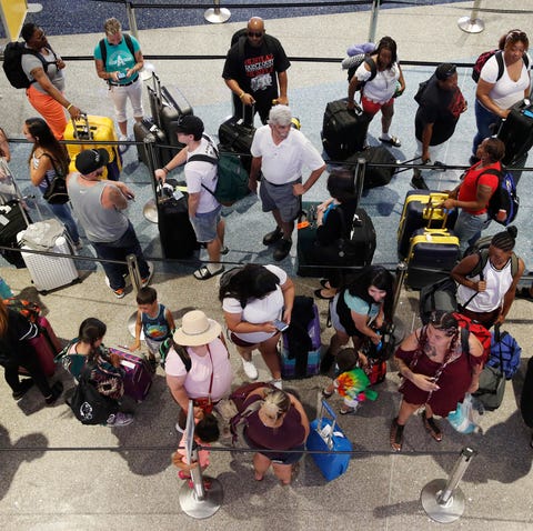 Travelers wait in line June 29, 2018, to check in 