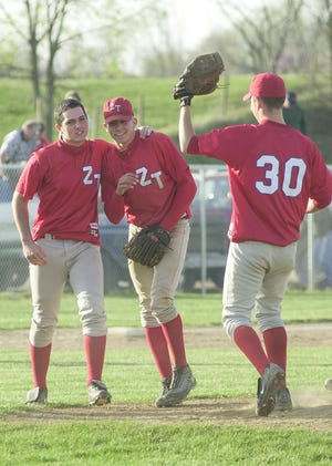 Andrew Davis, middle, celebrates with fellow teammates, including Tyler Wertman, during a game against Adena. 