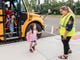McCutchanville Elementary School counselor Rachel Bauer greets students while exiting the buses on the first day of school Wednesday, August 8, 2018. 