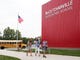 Ashley Lee, middle, takes a photo of second grader Jackson Lee, front, carrying his sister Annaston up the sidewalk while older sister Madison Lee, fifth grade, trails behind on the first day of school at McCutchanville Elementary Wednesday, August 8, 2018.