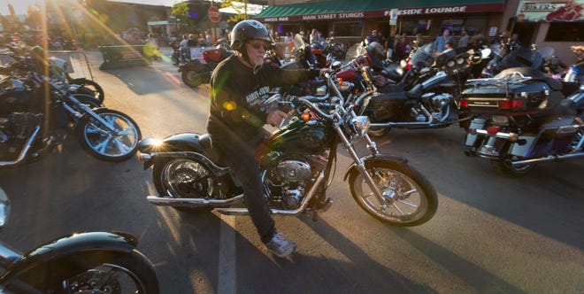 Henry Longbrake from California pulls out of his parking spot Tuesday in Sturgis, S.D.