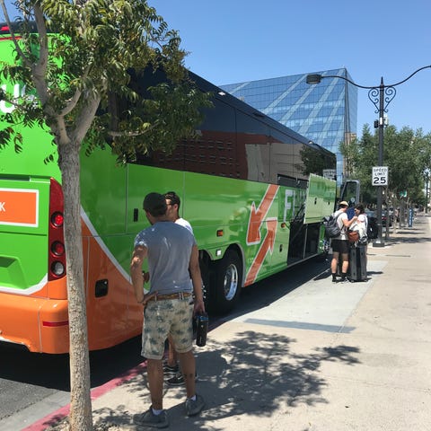 A FlixBus picks up passengers at a stop in downtow