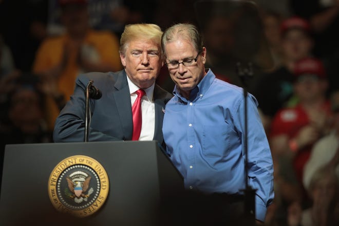 President Donald Trump greets Republican candidate for U.S. Senate Mike Braun at a campaign rally on May 10, 2018 in Elkhart, Ind. The crowd filled the 7,500-person-capacity gymnasium.