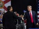 President Donald Trump shakes hands with US Representative Ron DeSantis, Republican of Florida, and candidate for Florida Governor, as he speaks during a campaign rally at Florida State Fairgrounds Expo Hall in Tampa, Fla. on July 31, 2018. 