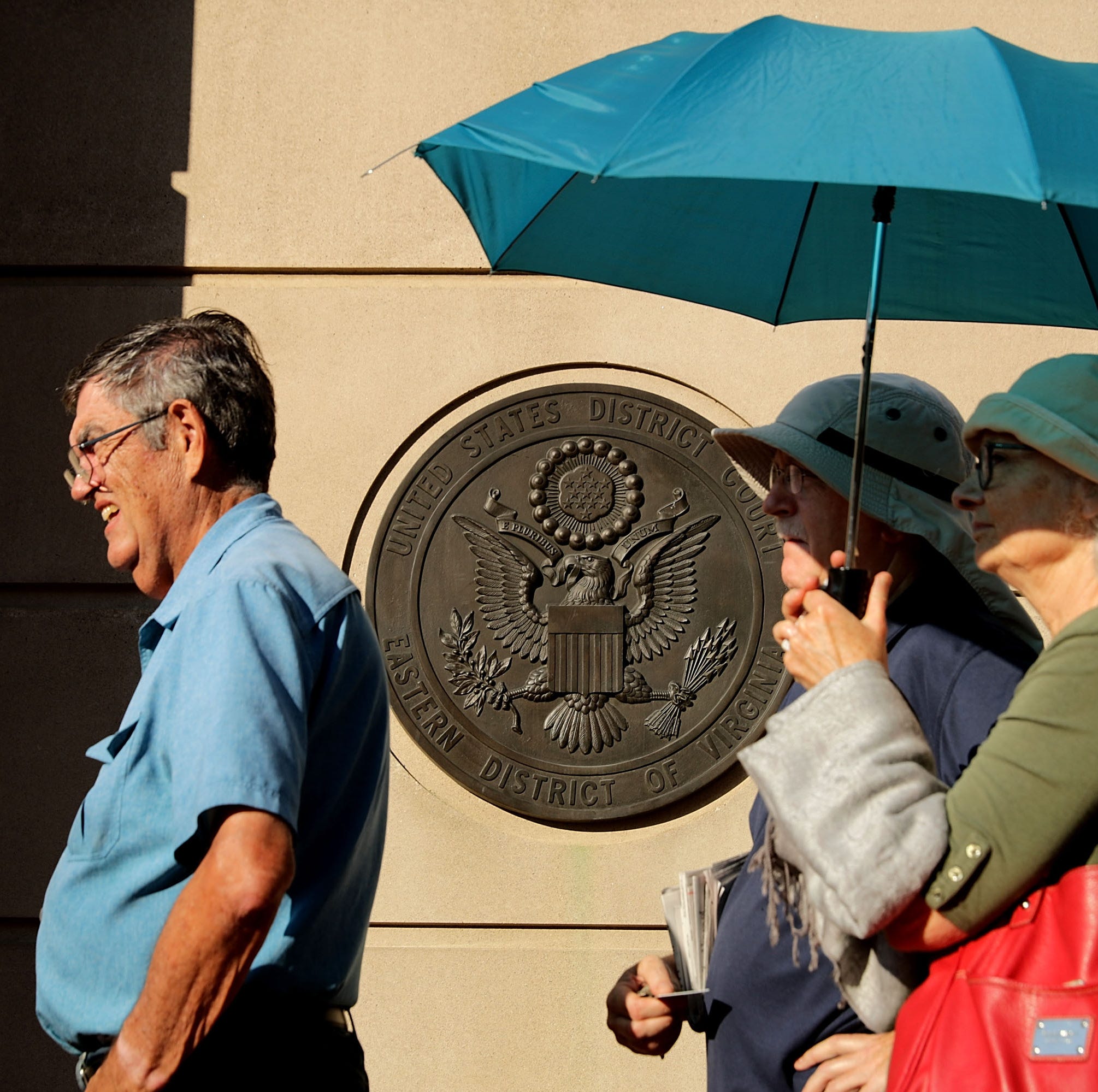People line up outside the Albert V. Bryan U.S. Courthouse on the seventh day of former Trump campaign chairman Paul Manafort's trial Aug. 8, 2018 in Alexandria, Virginia.