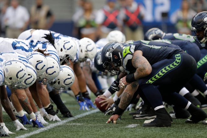Seattle Seahawks and Indianapolis Colts players line up on the line of scrimmage during the first half of an NFL football preseason game, Thursday, Aug. 9, 2018, in Seattle.
