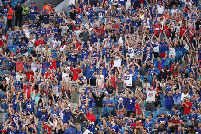 Fans join in to do the wave around New Era Field. 
