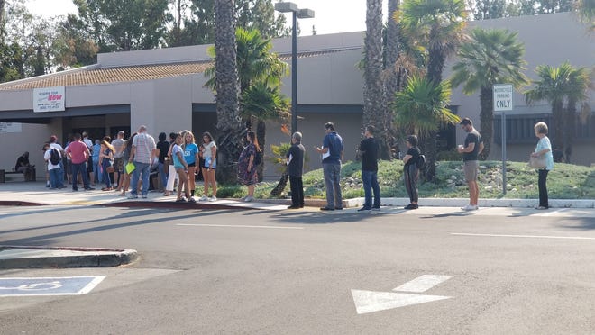Long lines form outside the Thousand Oaks DMV office Thursday as walk-in customers prepare for an hours-long wait for service.