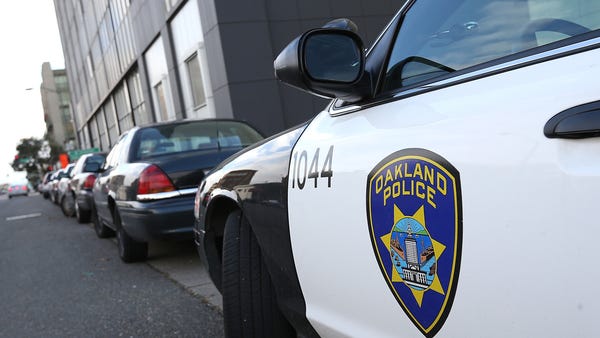 An Oakland Police Department patrol car sits in...