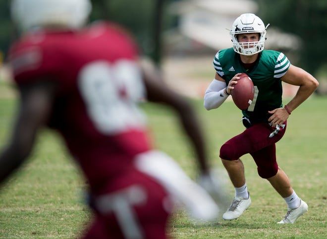Troy University quarterback Kaleb Barker rolls out during the scrimmage in Troy, Ala. on Saturday August 11, 2018. 