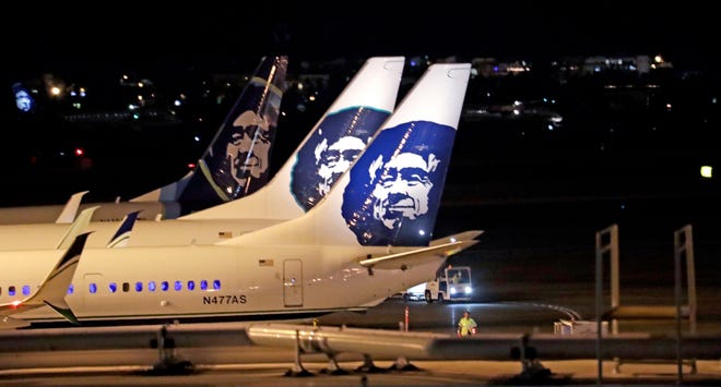 Alaska Airlines planes sit on the tarmac at Sea-Tac International Airport Friday evening, Aug. 10, 2018, in SeaTac, Wash. An airline mechanic stole an Alaska Airlines plane without any passengers and took off from Sea-Tac International Airport in Washington state on Friday night before crashing near Ketron Island, officials said. (AP Photo/Elaine Thompson)