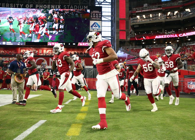 Arizona Cardinals arrive for pregame warms-up before playing the L.A. Chargers during a preseason NFL football game on Aug. 11, 2018 at University of Phoenix Stadium in Glendale, Ariz.