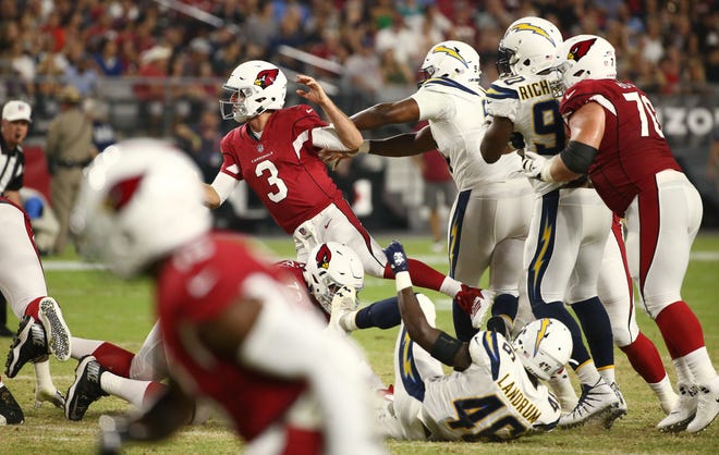 Arizona Cardinals Josh Rosen is pushed to the turf by L.A. Chargers Corey Liuget in the first half during a preseason NFL football game on Aug. 11, 2018 at University of Phoenix Stadium in Glendale, Ariz.