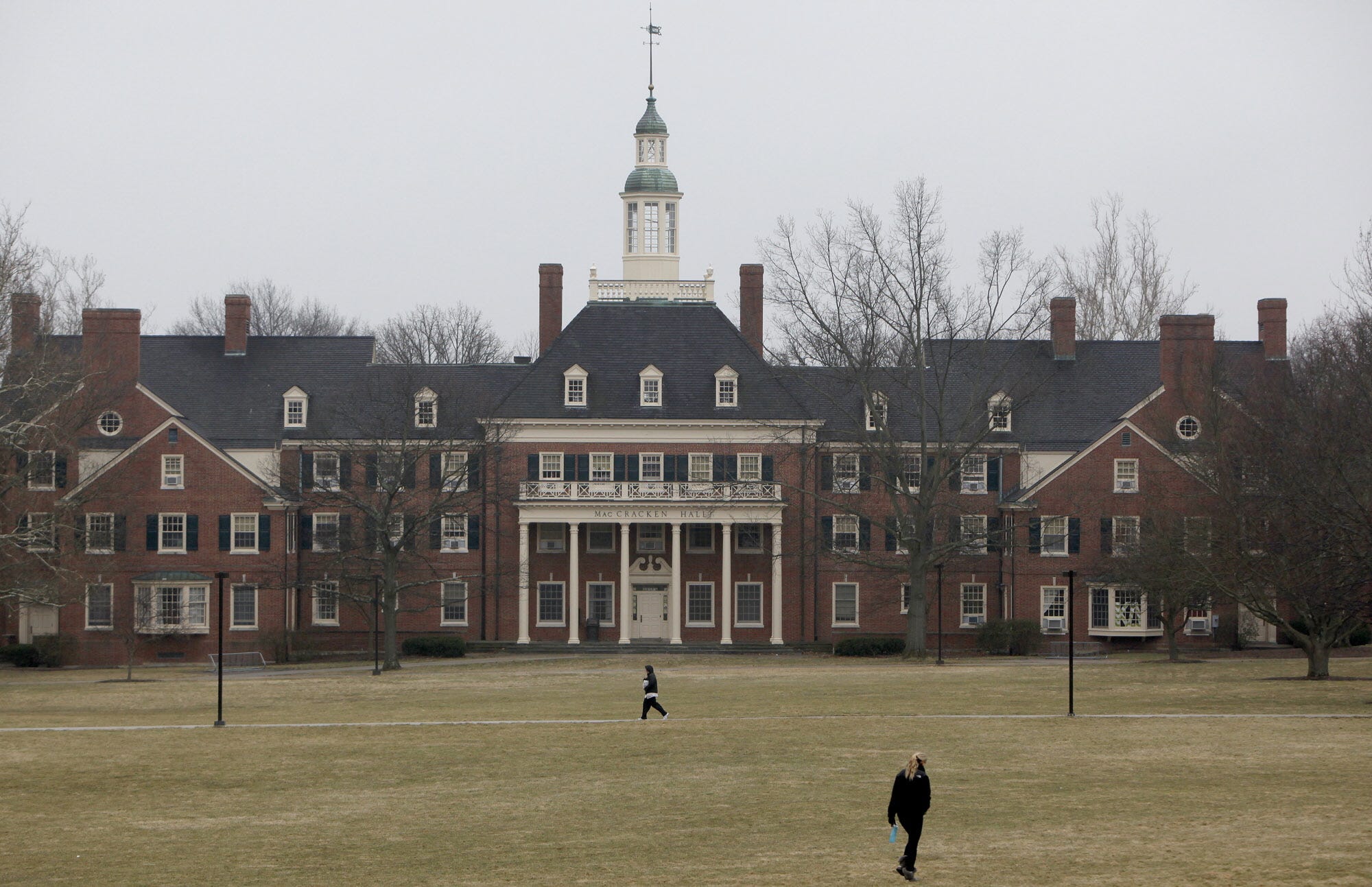 Students walk across the lawn in front of MacCracken Hall at Miami University, in Oxford, Ohio on March 5, 2013.