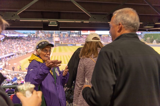 Colorado Rockies usher Mary O'Dell greets fans at a recent home game at Coors Field. She has been Rockies usher for the past 20 years.