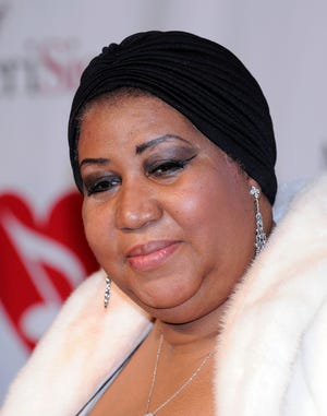 Aretha Franklin poses as she arrives at the MusiCares tribute to her where she was honored as their person of the year, in this  Feb. 8, 2008, file photo in Los Angeles. (AP Photo/Mark J. Terrill, file)