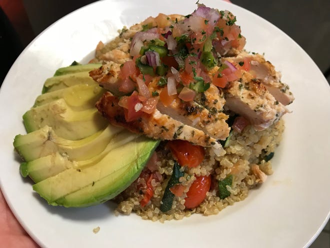 A quinoa bowl, topped with grilled chicken, is among the lunch dishes offered at Blades.