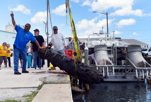A work crew from the City of Fort Pierce along with members of Maritime Research and Recovery hoist a cannon from the 1715 Spanish Plate Fleet out of the water at Fisherman's Wharf on Monday, Aug. 13, 2018 in Fort Pierce. The recovery of the cannon, discovered in the remains of a shipwreck off Sandy Point, is a collaboration between the Keep Fort Pierce Beautiful Advisory Board and the Fort Pierce Lions Club. The restoration of the cannon will take about three years and will be put on display in the plaza at Melody Lane Fishing Pier.