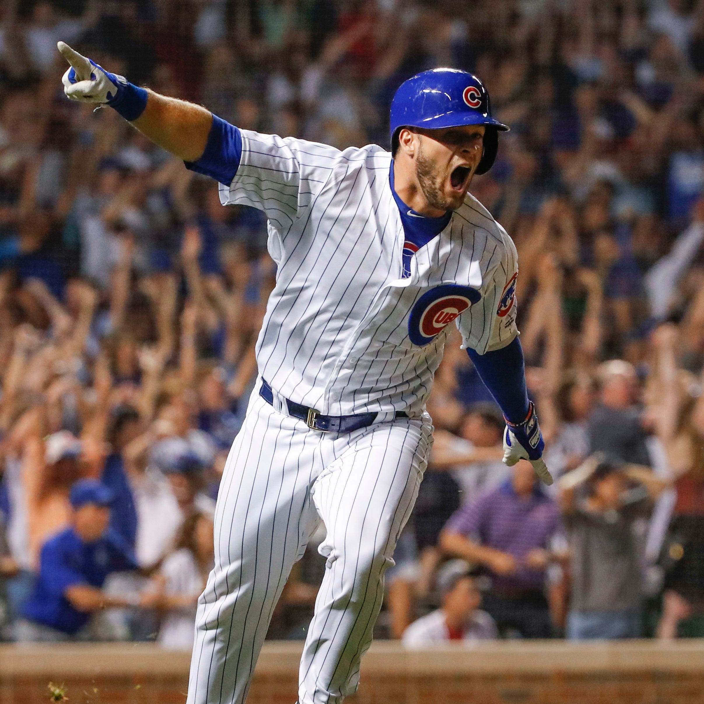Chicago Cubs third baseman David Bote (13) reacts after hitting game winning grand slam against the Washington Nationals at Wrigley Field.